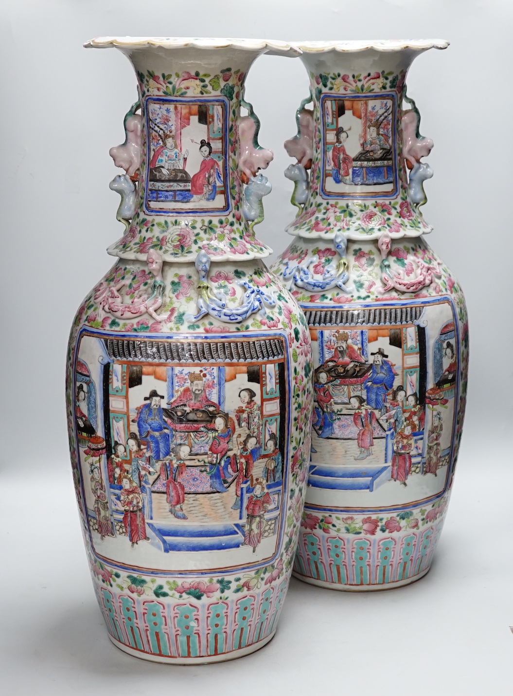 A pair of large Chinese porcelain famille rose vases, 19th century, decorated with court scenes and flowers, 61cm high